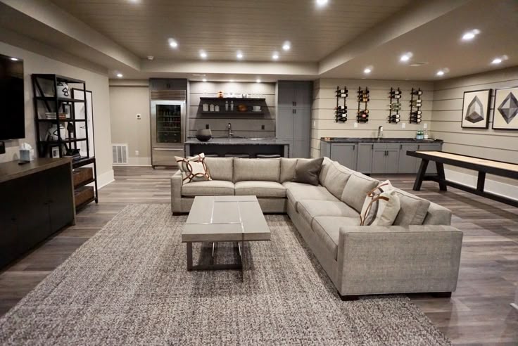 Cozy basement living area with sectional sofa and warm lighting.