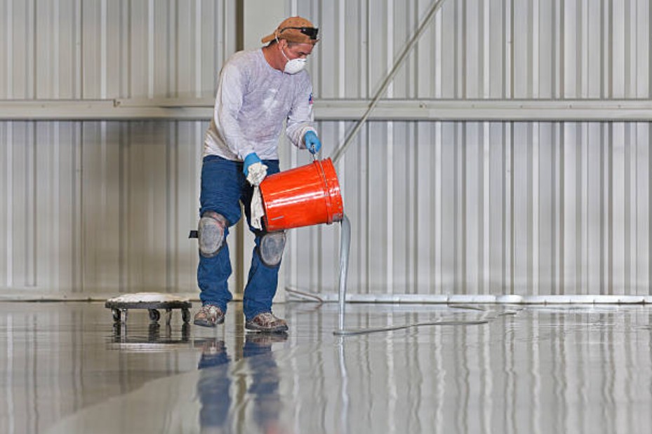 McAze crew applying glossy epoxy flooring in a Toronto garage with flake finish and seamless coating.